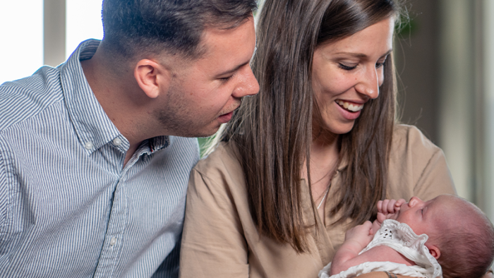 Parents holding a newborn baby